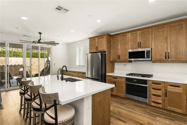 a kitchen with stainless steel appliances granite countertop a stove and a microwave