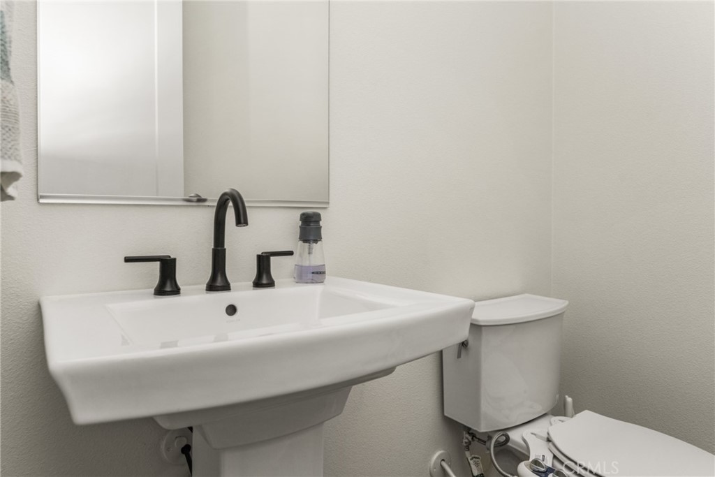 11786 Glenridge Road Corona, CA 92883 - Photo 28 of 73 a bathroom with a sink a toilet and mirror