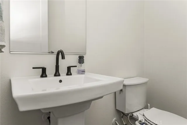 a spacious bathroom with a double vanity sink a mirror and a shower
