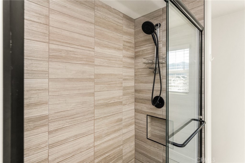 11786 Glenridge Road Corona, CA 92883 - Photo 34 of 73 Walk-in shower with tile surround and glass enclosure for a modern look and feel.