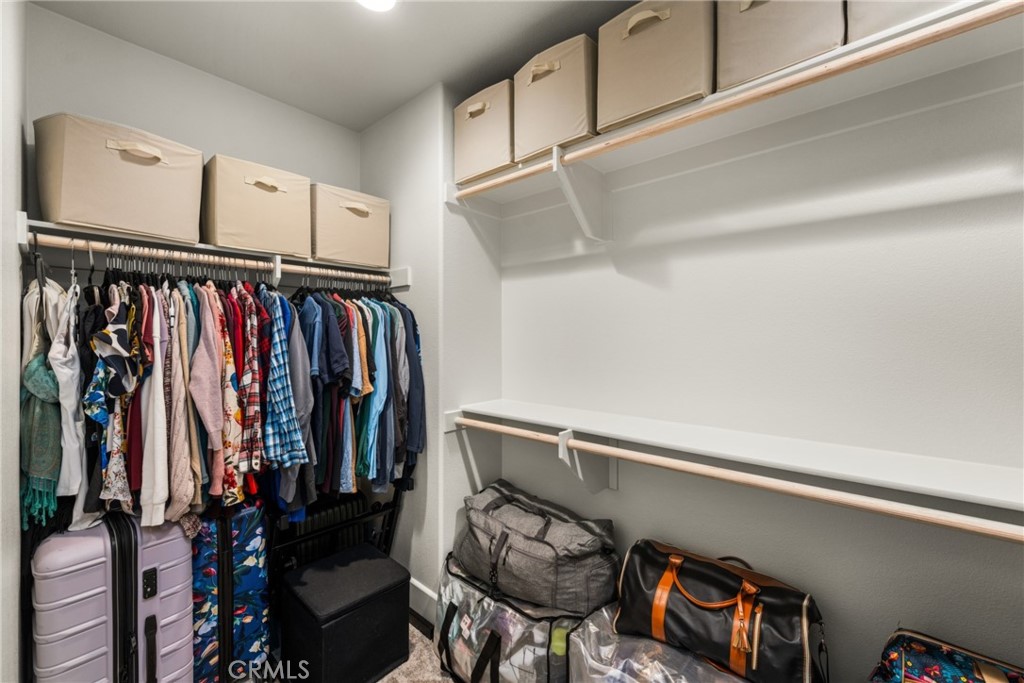 11786 Glenridge Road Corona, CA 92883 - Photo 36 of 73 a view of walk in closet with clothes and shoes