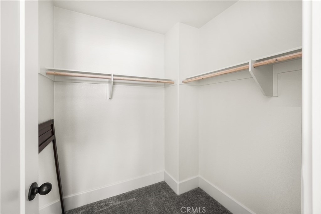 11786 Glenridge Road Corona, CA 92883 - Photo 41 of 73 a view of walk in closet with empty racks