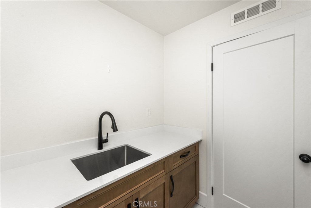 11786 Glenridge Road Corona, CA 92883 - Photo 46 of 73 Large utility sink and folding counter space in the dedicated upstairs laundry room.
