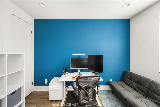 a view of a hallway with wooden floor fireplace and living room