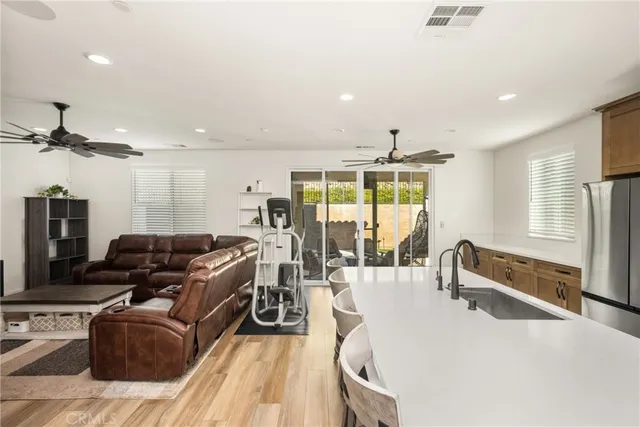 a view of a kitchen with kitchen island granite countertop a sink and a large window