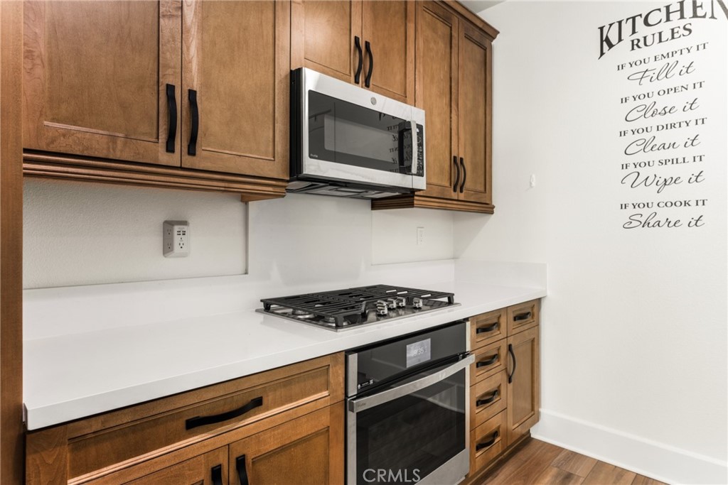 11786 Glenridge Road Corona, CA 92883 - Photo 10 of 73 a kitchen with stainless steel appliances granite countertop a stove and a microwave