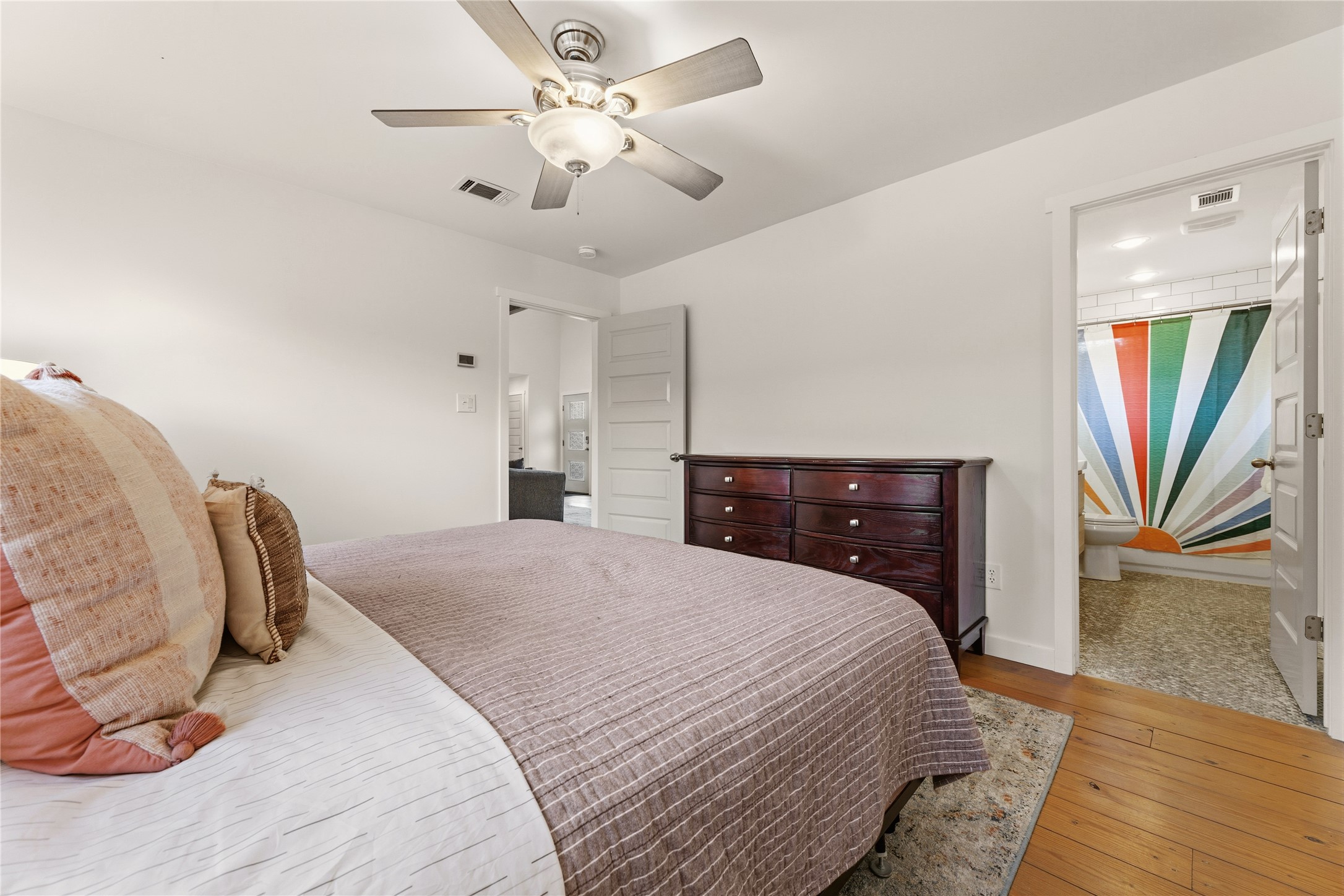 12901 Wire Road Leander, TX 78641 - Photo 13 of 40 Hardwood floors and crisp white walls create an inviting ambiance in this bedroom.