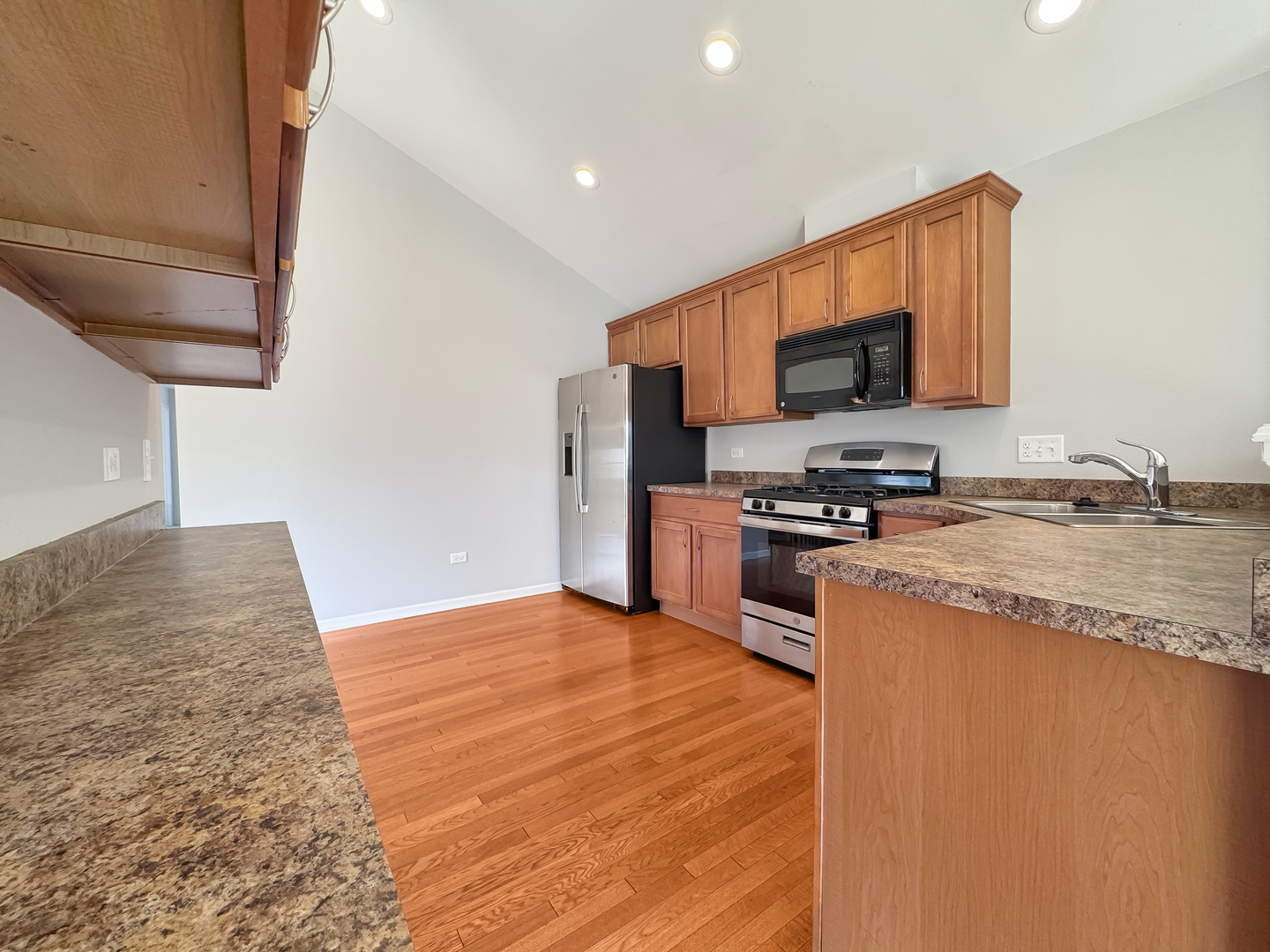 3381 Cameron Drive, Unit 1 Elgin, IL 60124 - Photo 12 of 26 a kitchen with stainless steel appliances granite countertop a stove a sink and a refrigerator