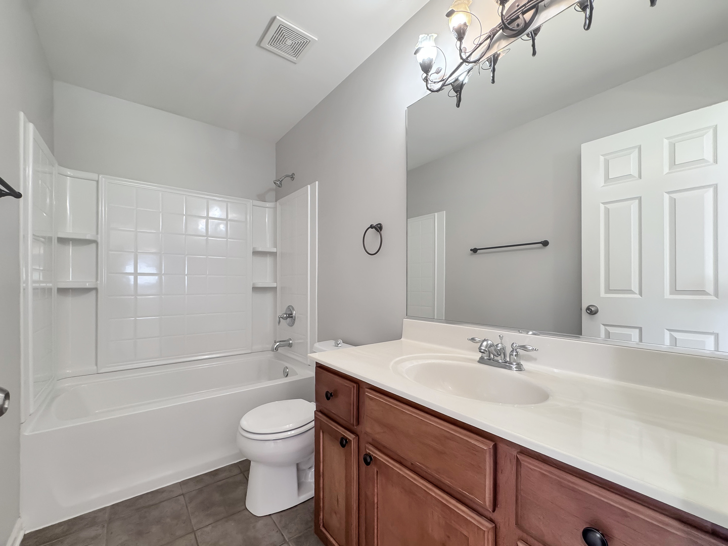 3381 Cameron Drive, Unit 1 Elgin, IL 60124 - Photo 20 of 26 a bathroom with a sink a toilet and a large mirror