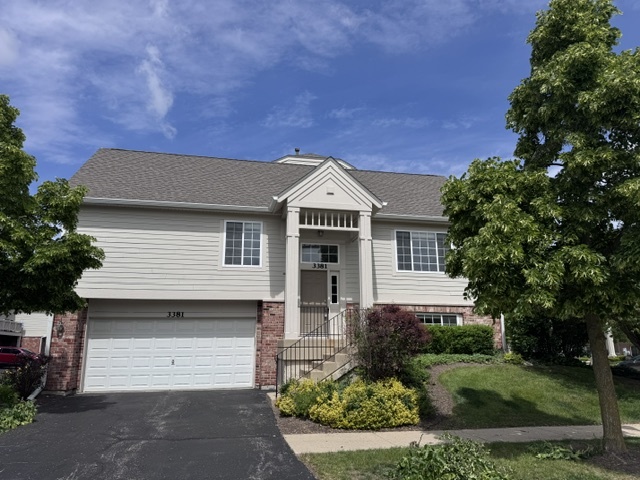 3381 Cameron Drive, Unit 1 Elgin, IL 60124 - Photo 25 of 26 a front view of a house with a yard