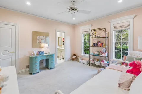 a bedroom with furniture and a window