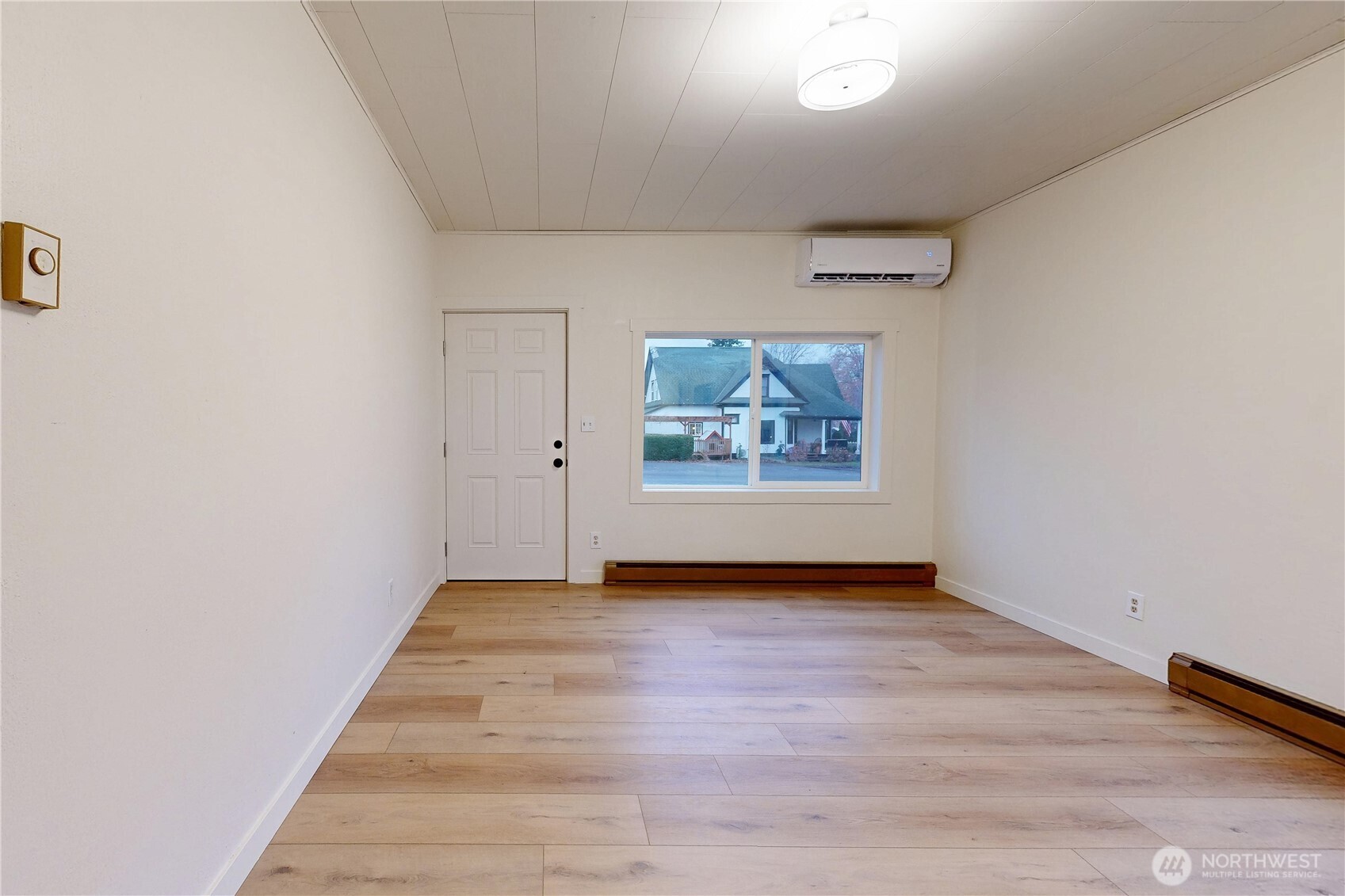 1209 Chestnut Street Milton Freewater, OR 97862 - Photo 3 of 23 an empty room with wooden floor and windows