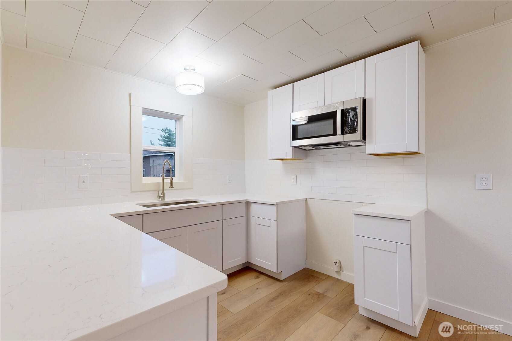 1209 Chestnut Street Milton Freewater, OR 97862 - Photo 8 of 23 a kitchen with stainless steel appliances granite countertop white cabinets a microwave a sink and dishwasher