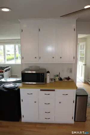 a kitchen with granite countertop white cabinets and sink