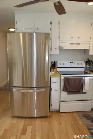 a kitchen with wooden cabinets and white appliances