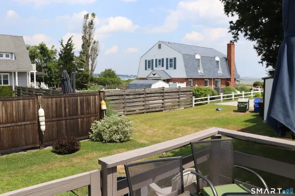 a view of a chairs and table in the backyard