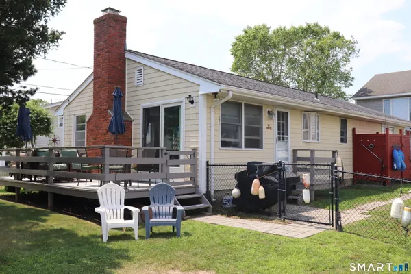 a view of a house with a backyard porch and sitting area