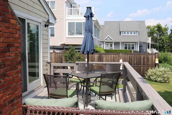 a view of a patio with table and chairs