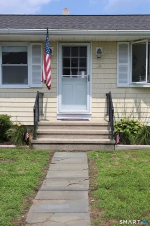 a front view of a house with a yard and a garage
