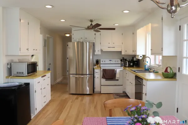 a kitchen with kitchen island a sink stainless steel appliances and cabinets