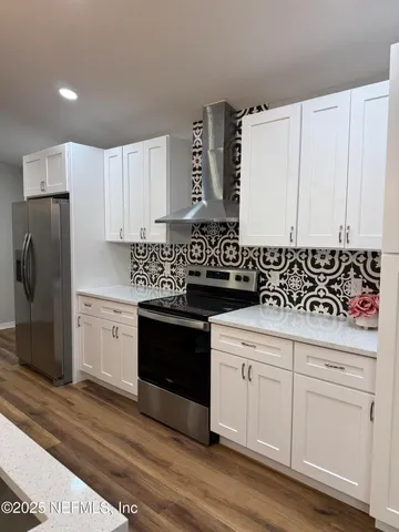 a kitchen with kitchen island sink stove and refrigerator