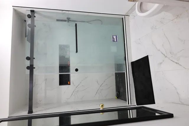 a bathroom with a shower and a mirror