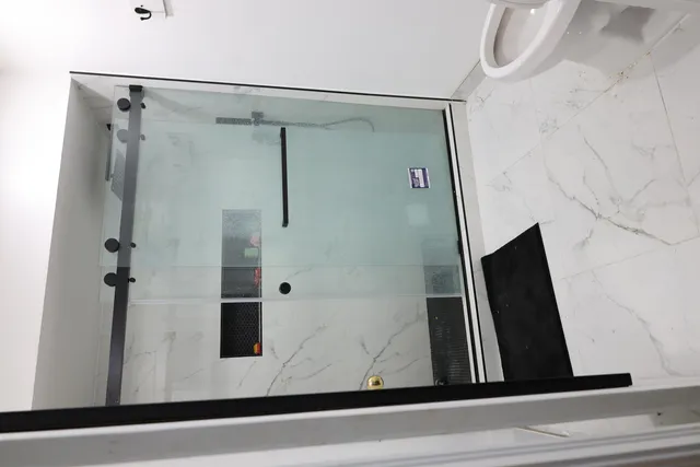 a bathroom with a shower and a mirror