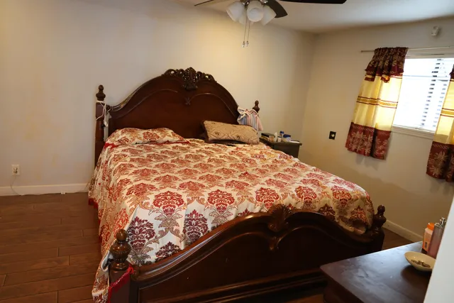 a bedroom with a bed and window