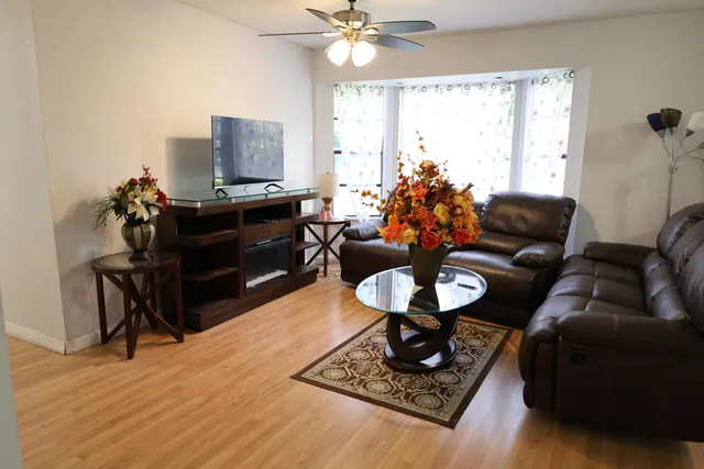 a living room with furniture and a wooden floor