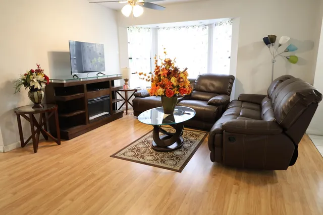 a living room with furniture and a wooden floor