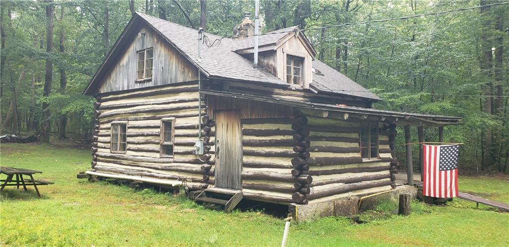 a view of a house with backyard and deck