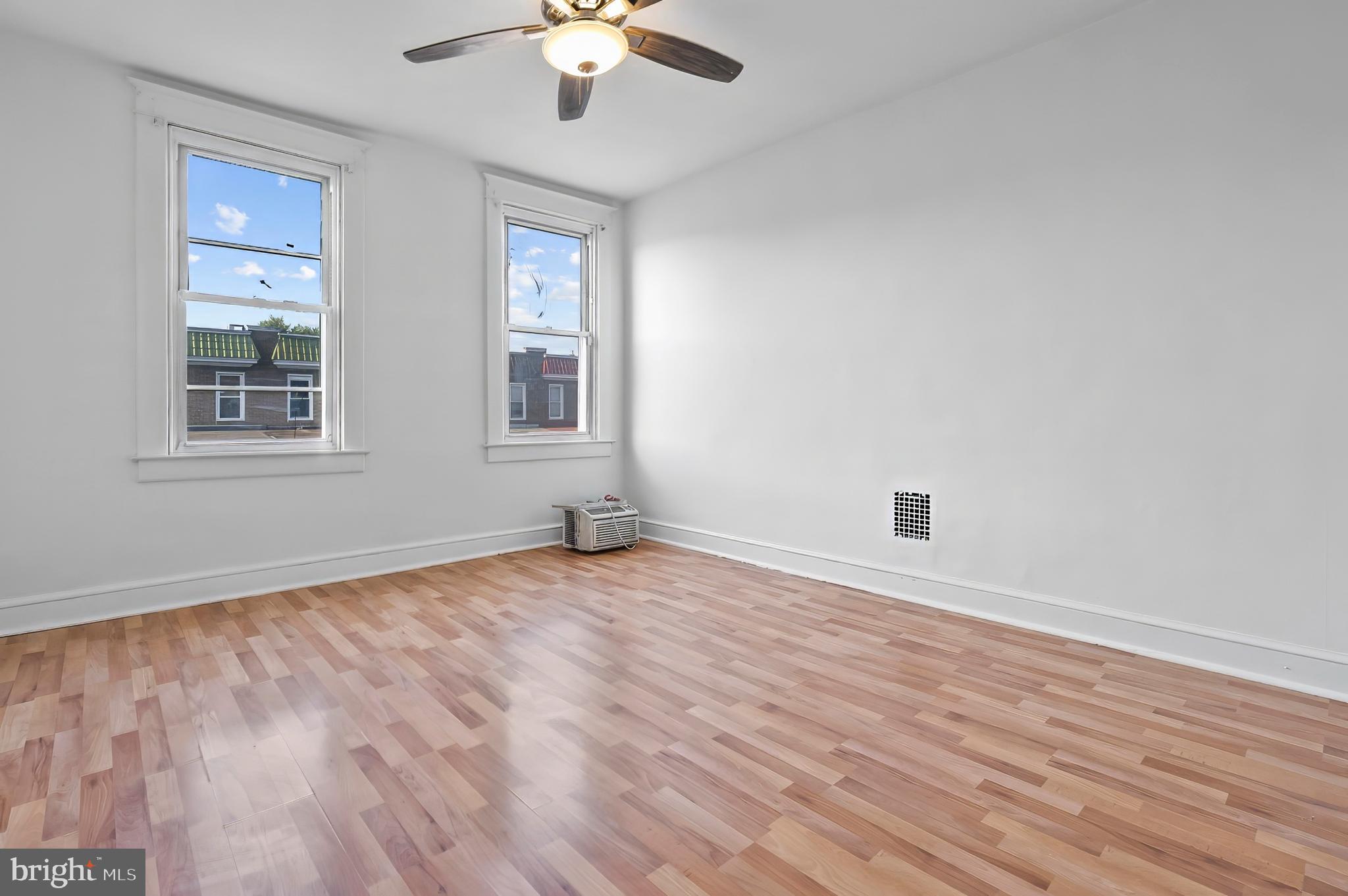 3105 Mareco Avenue Baltimore, MD 21213 - Photo 14 of 27 an empty room with wooden floor and windows
