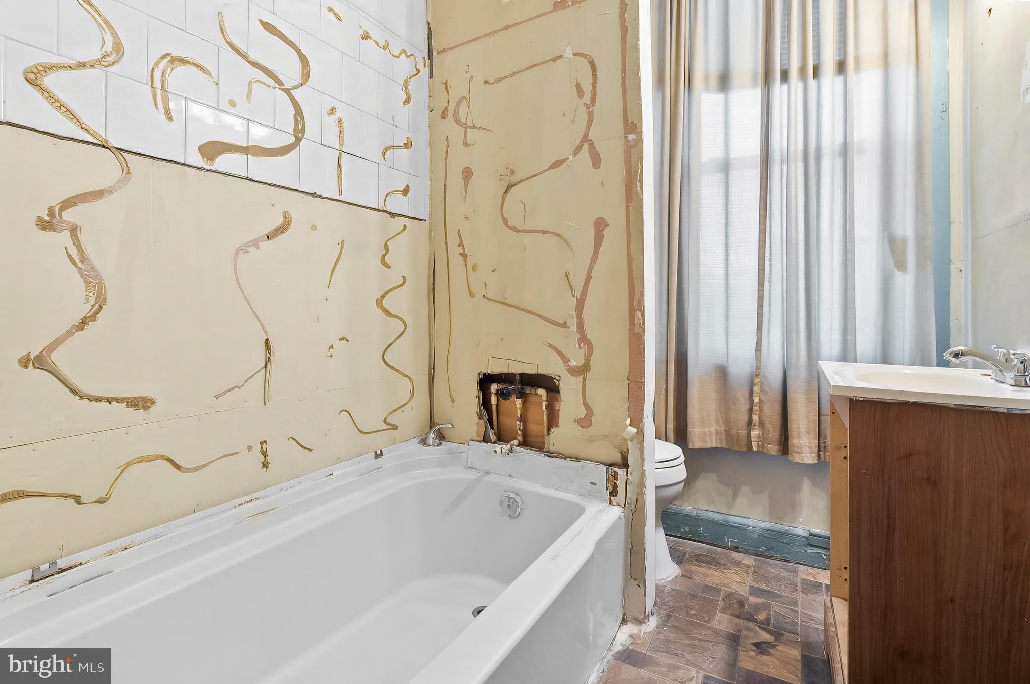 3105 Mareco Avenue Baltimore, MD 21213 - Photo 16 of 27 a bathroom with a bathtub and shower