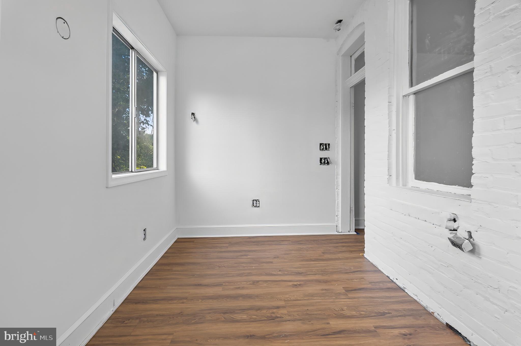 3105 Mareco Avenue Baltimore, MD 21213 - Photo 17 of 27 a view of an empty room with wooden floor and a window