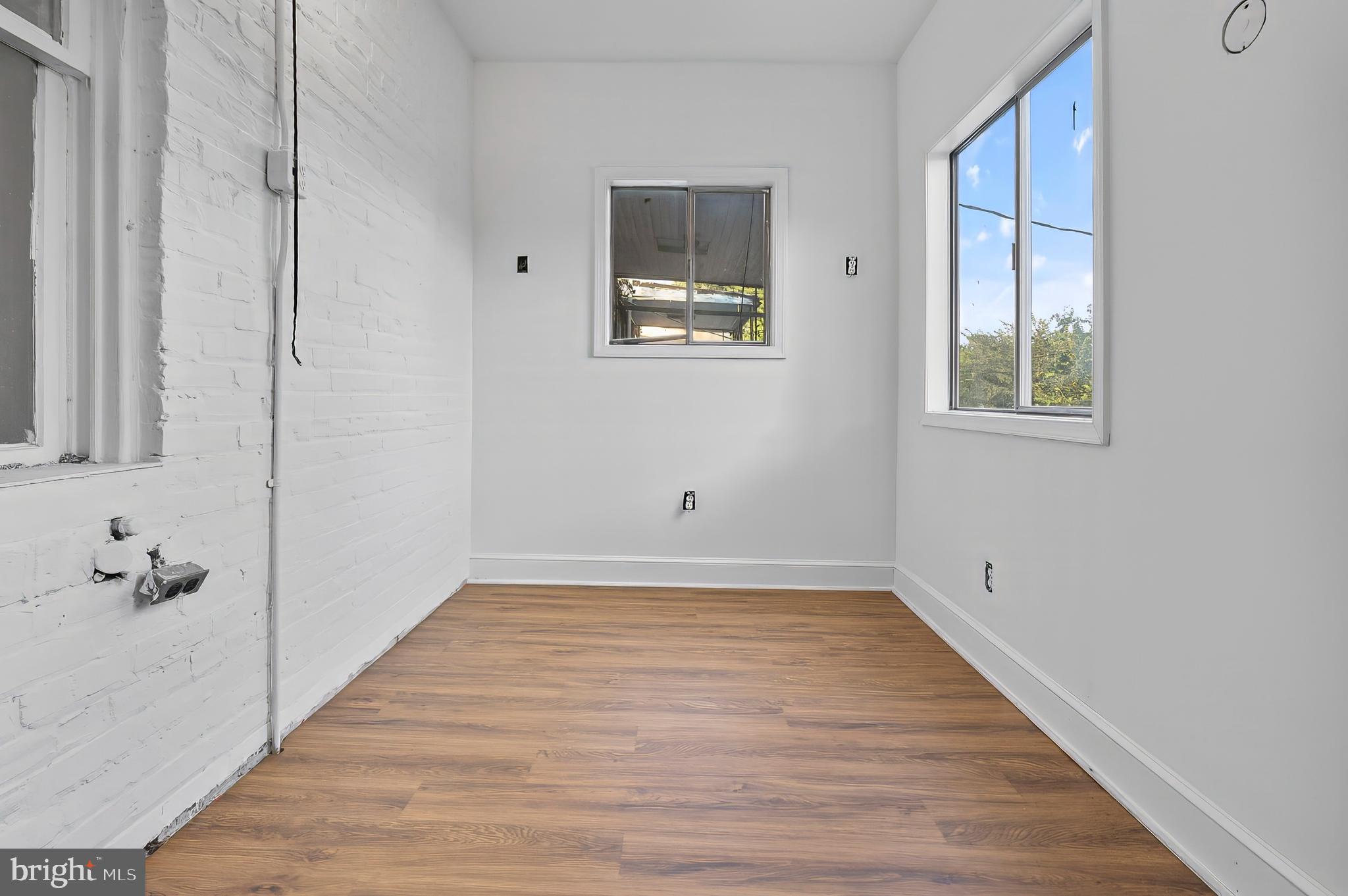 3105 Mareco Avenue Baltimore, MD 21213 - Photo 18 of 27 a view of an empty room with wooden floor and a window