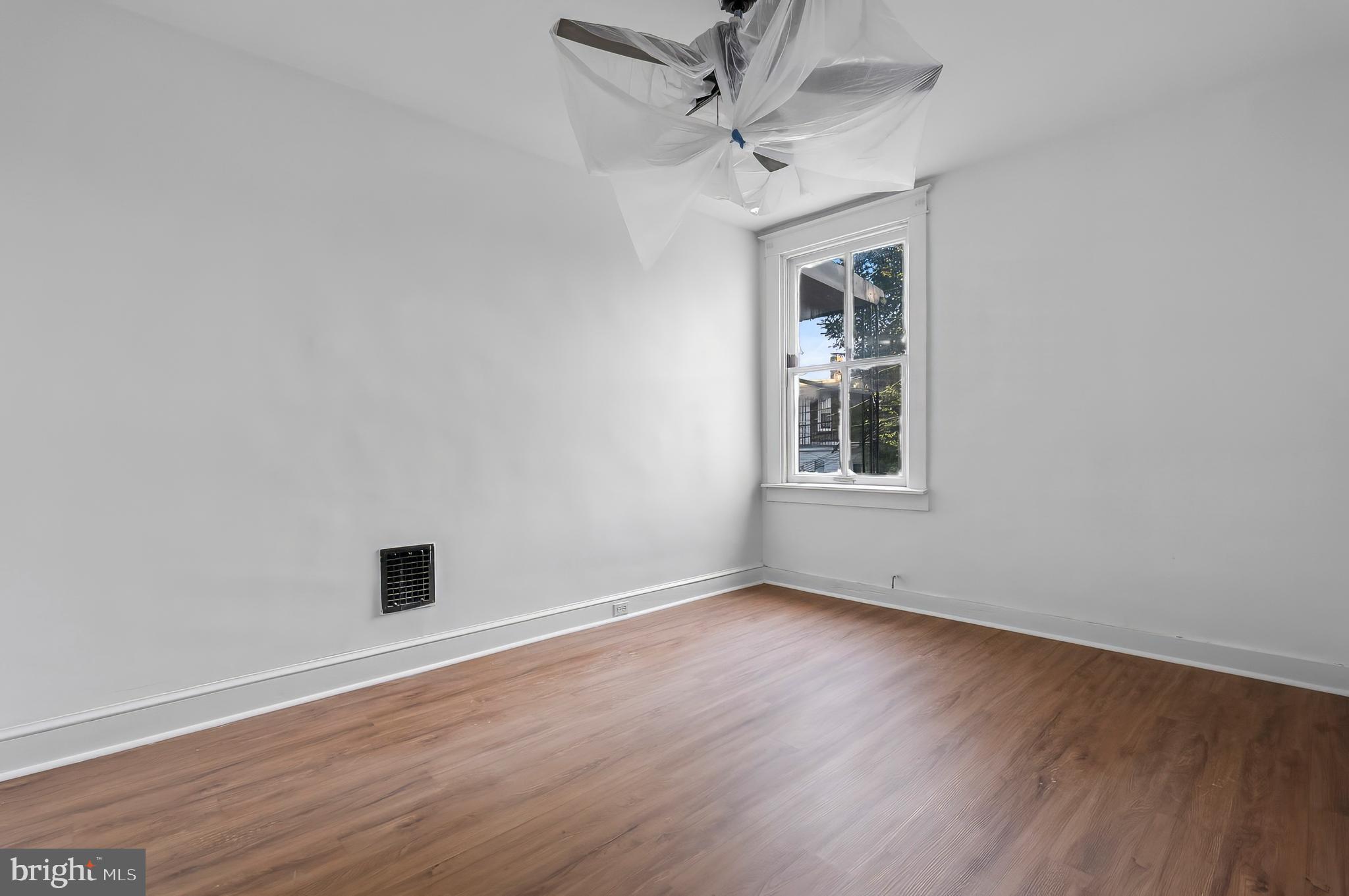 3105 Mareco Avenue Baltimore, MD 21213 - Photo 20 of 27 a view of an empty room with wooden floor and a window