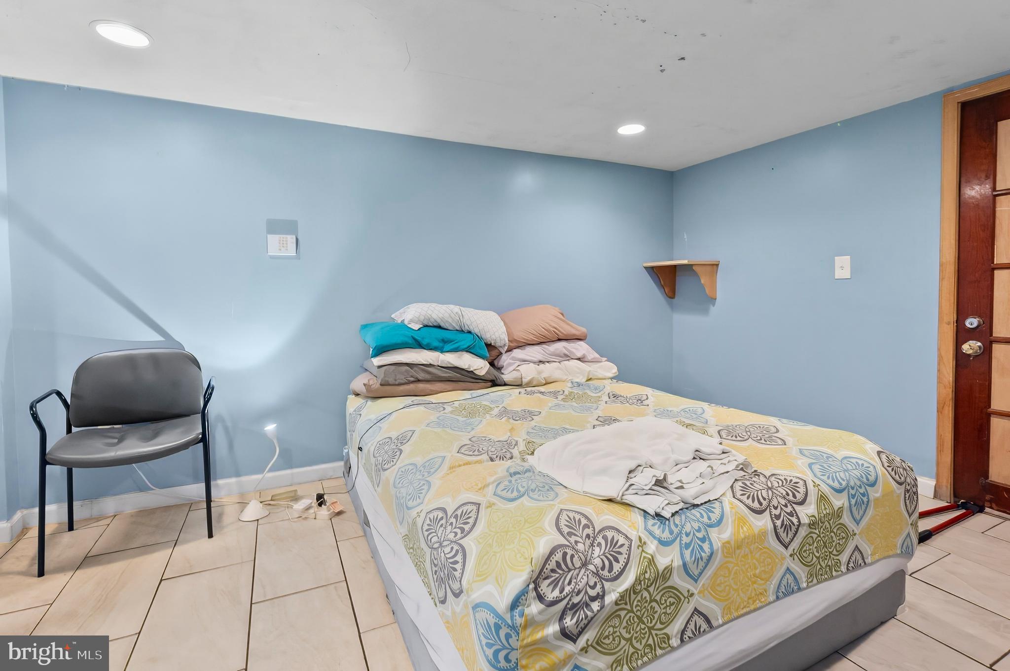 3105 Mareco Avenue Baltimore, MD 21213 - Photo 23 of 27 a bedroom with a bed and chair