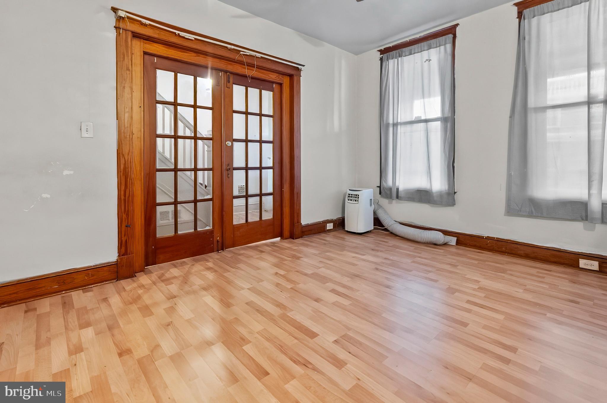 3105 Mareco Avenue Baltimore, MD 21213 - Photo 4 of 27 an empty room with wooden floor and windows