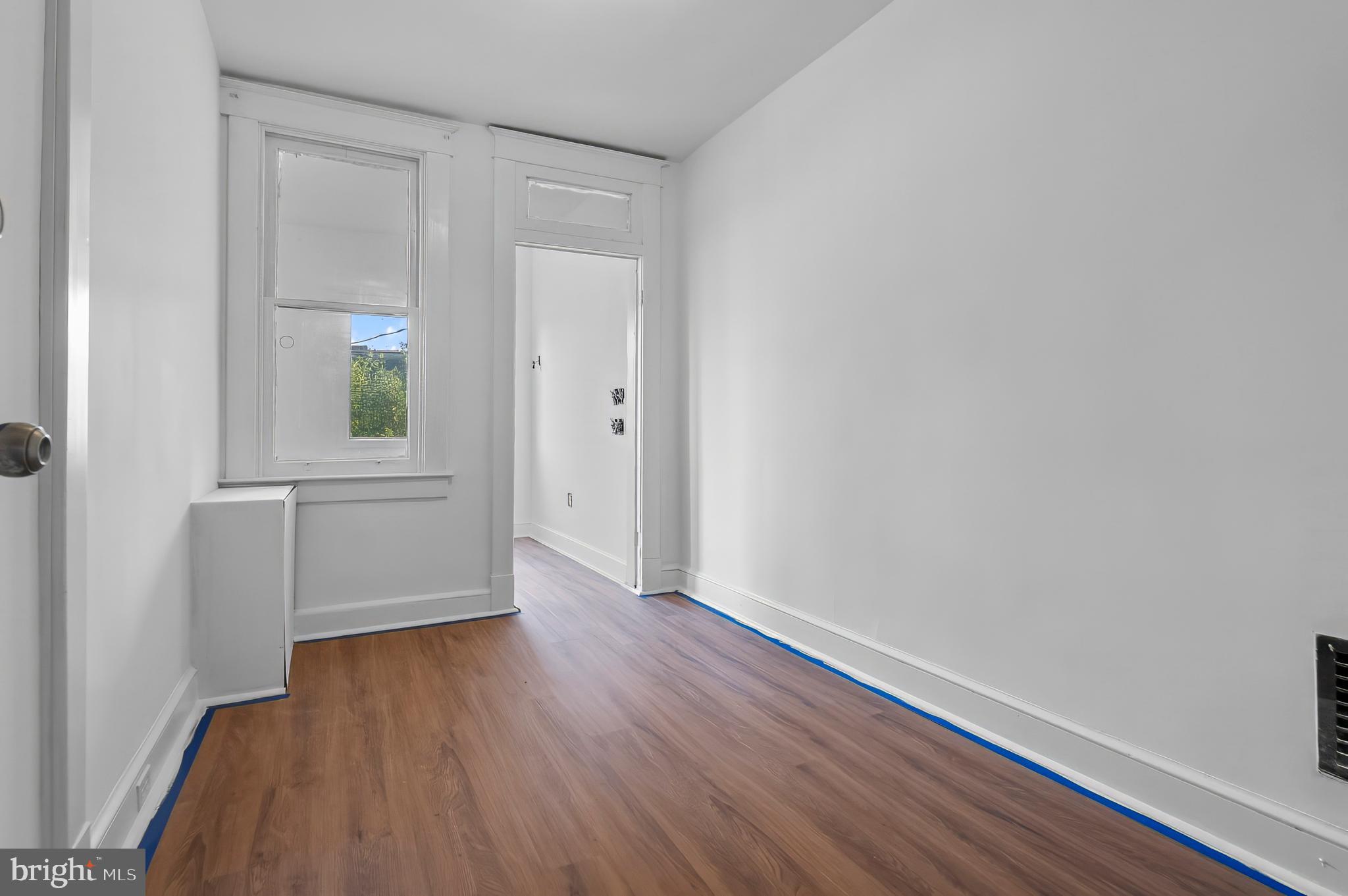 3105 Mareco Avenue Baltimore, MD 21213 - Photo 8 of 27 an empty room with wooden floor and windows