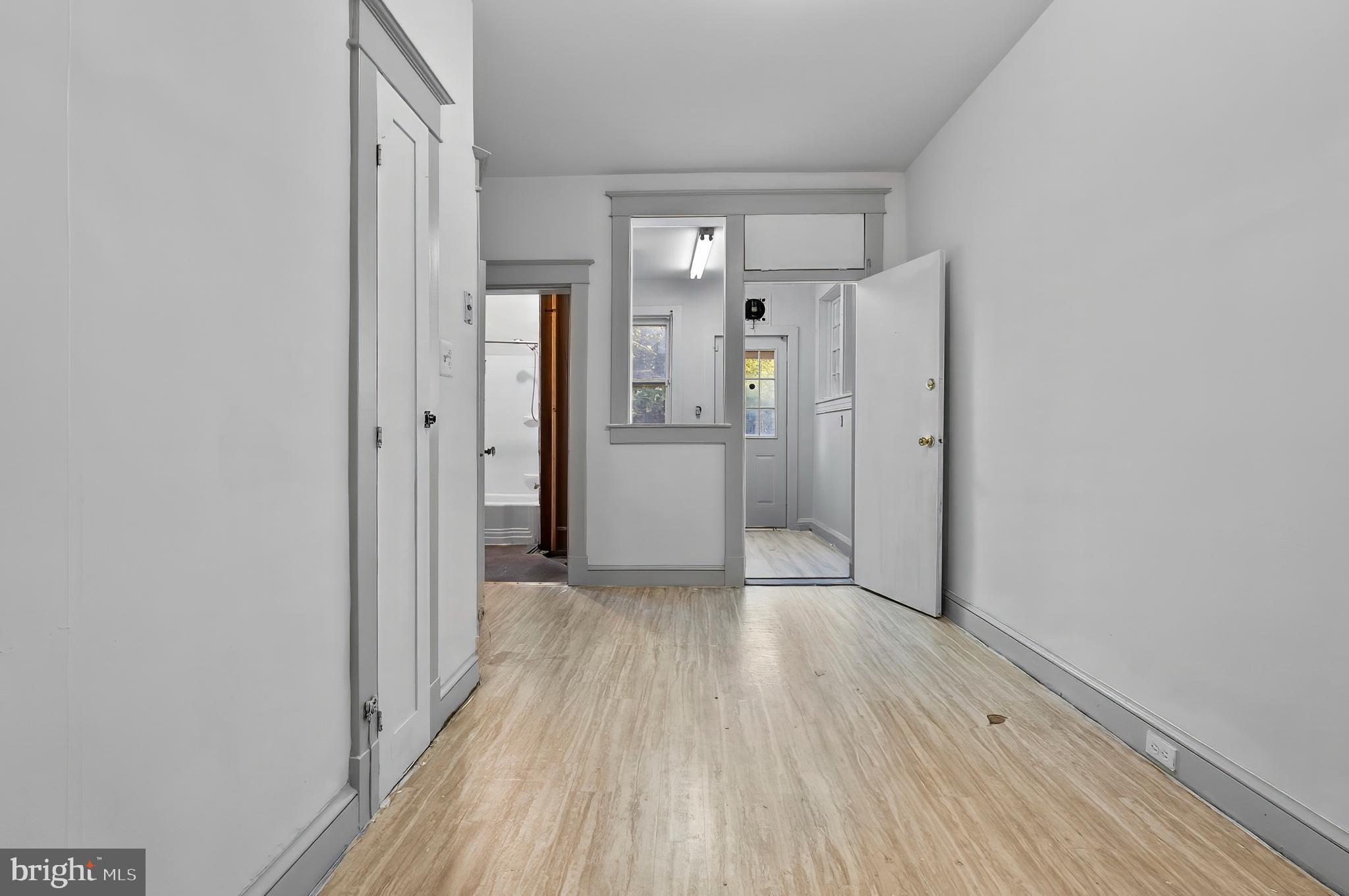 3105 Mareco Avenue Baltimore, MD 21213 - Photo 9 of 27 a view of a hallway with wooden floor and a bathroom
