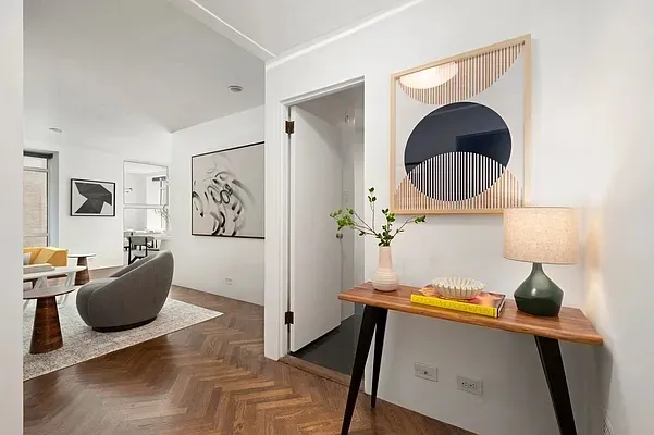 a living room with furniture a fireplace and a potted plant