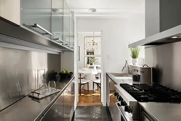a kitchen with a sink appliances and a window