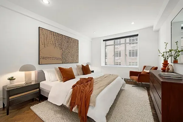 a view of a workspace with furniture and mirror