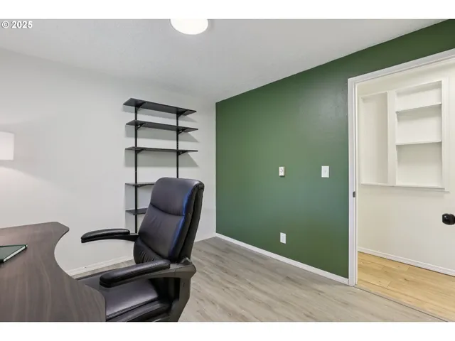a view of a room with furniture and wooden floor