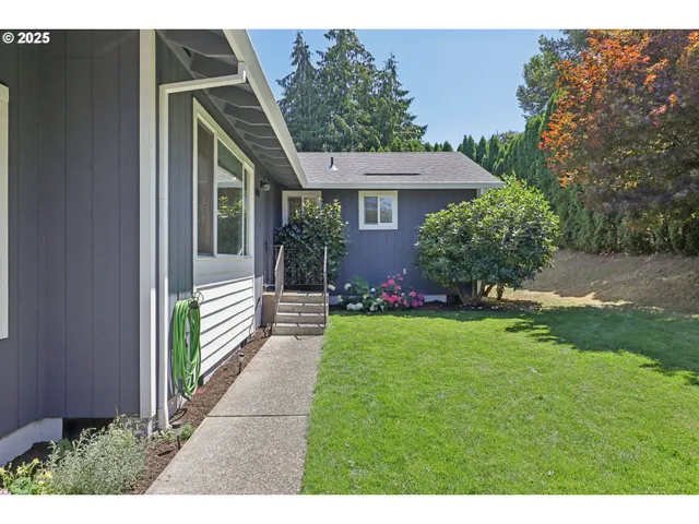 a view of a house with garden and yard