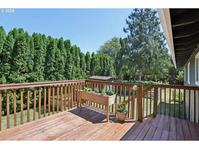 a view of balcony with wooden floor and fence