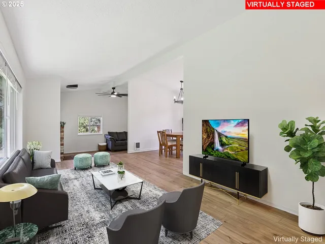 a living room with furniture a rug and a potted plant