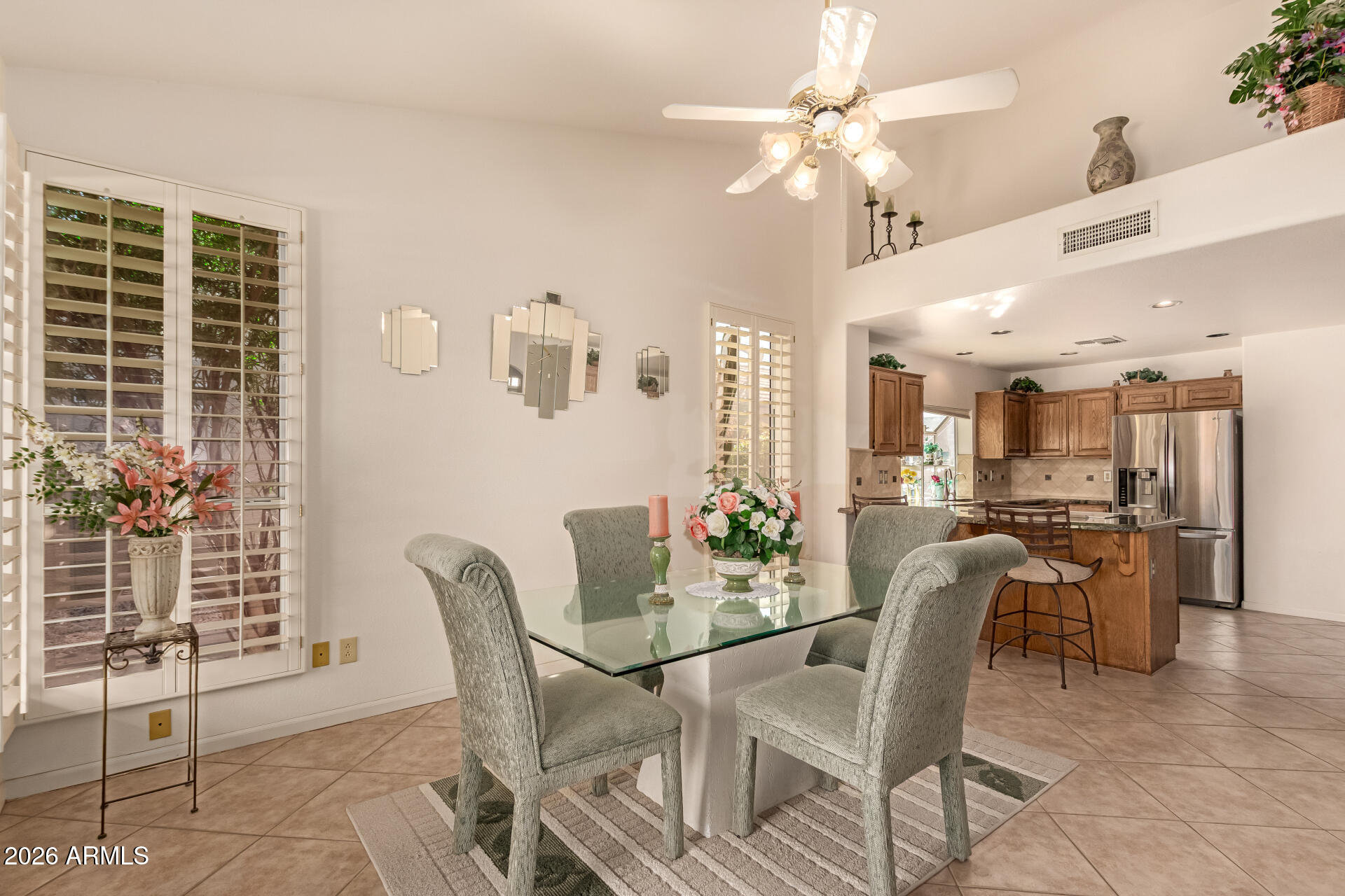 10904 East Spring Creek Road Sun Lakes, AZ 85248 - Photo 12 of 37 a view of a dining room with furniture and a chandelier