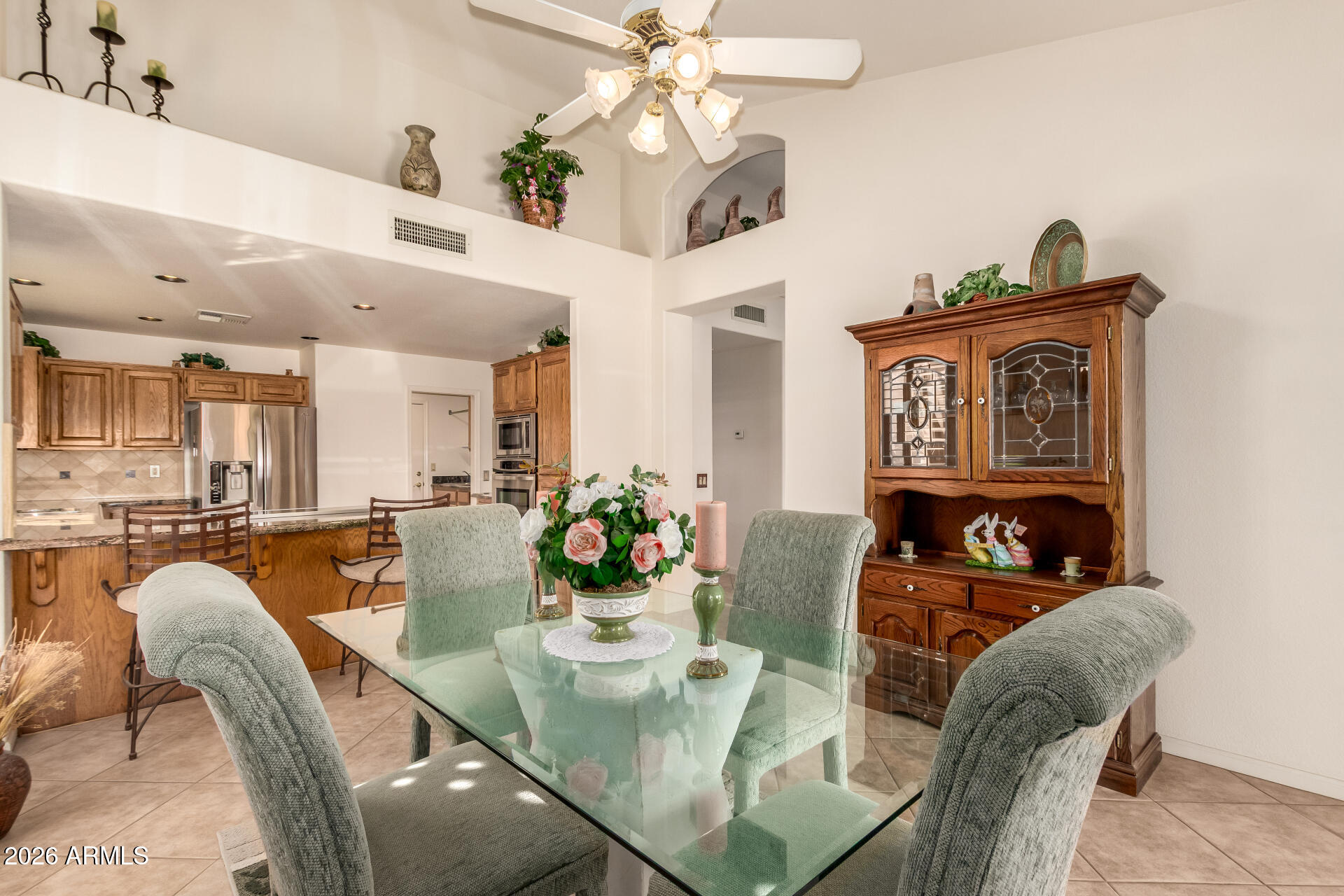 10904 East Spring Creek Road Sun Lakes, AZ 85248 - Photo 13 of 37 a view of a dining room with furniture a chandelier and wooden floor