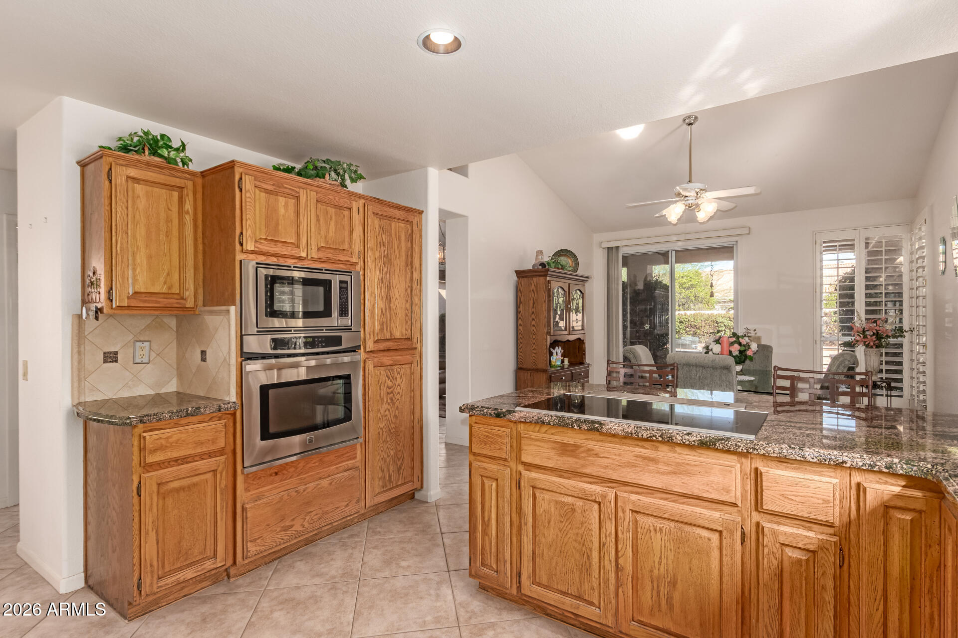 10904 East Spring Creek Road Sun Lakes, AZ 85248 - Photo 17 of 37 a kitchen with granite countertop a refrigerator stove and sink